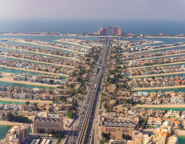 Aerial view of Dubai's Palm Jumeirah with luxury properties stretching out into the sea, showcasing prime real estate.